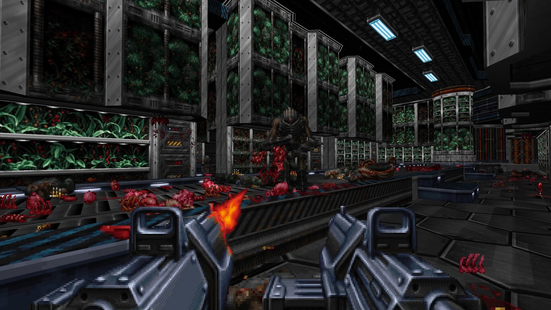 The player fires two weapons inside an industrial hall.