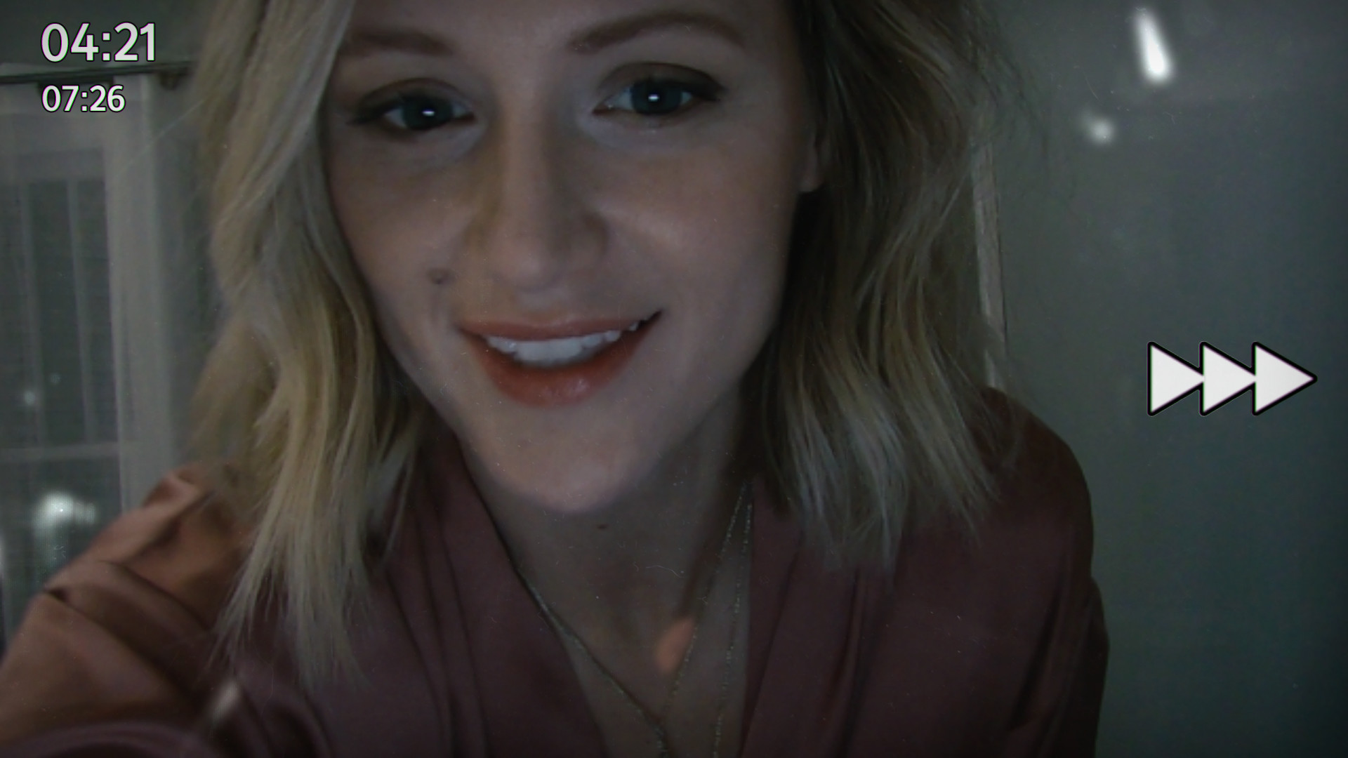 A woman appears in a paused video conversation.