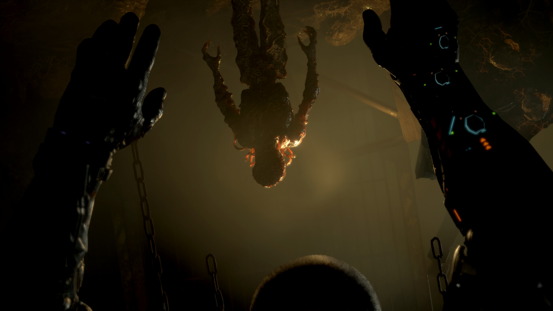 A figure hangs in a dim chamber seen from below.