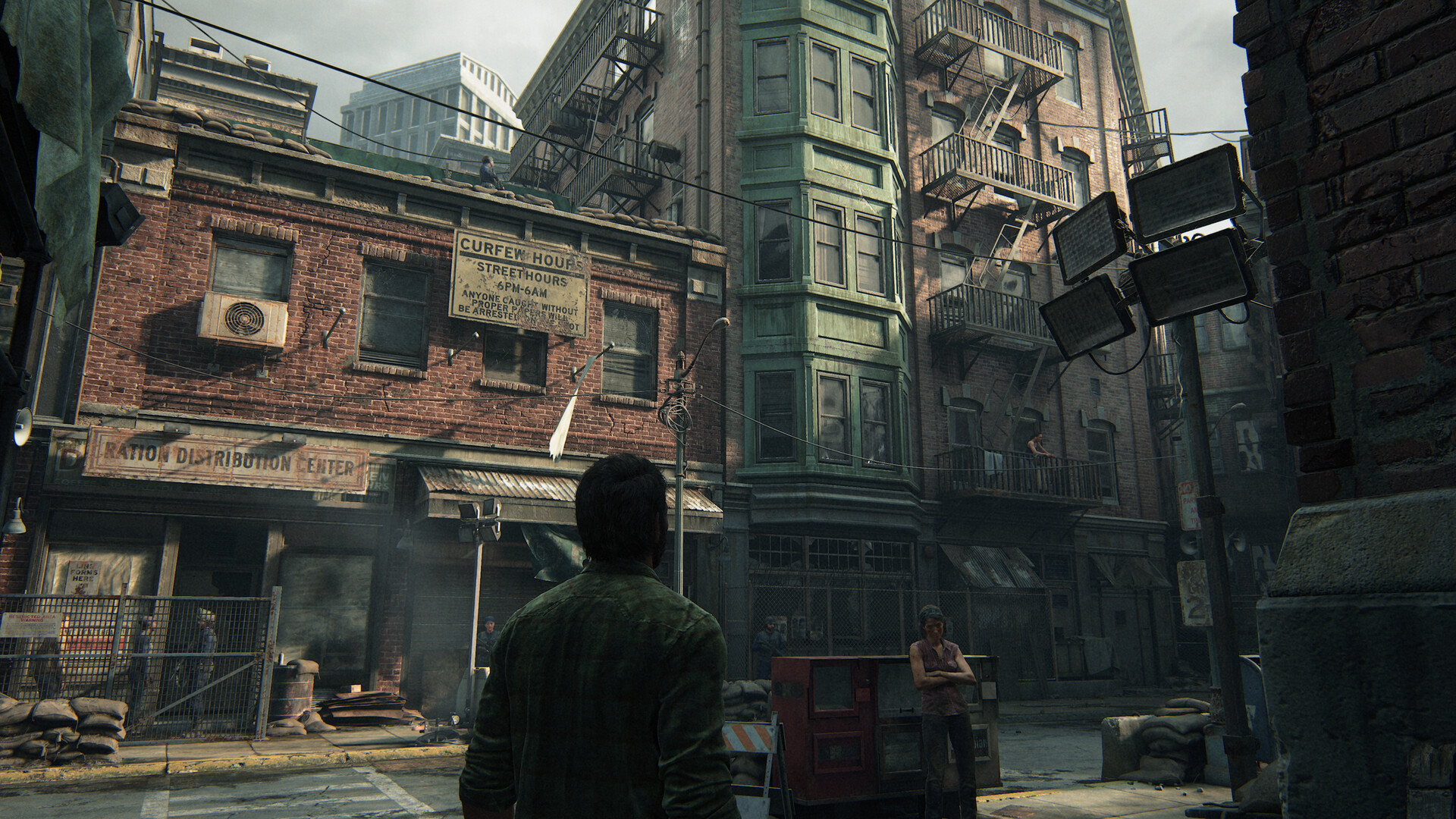Joel stands in a weathered urban street.