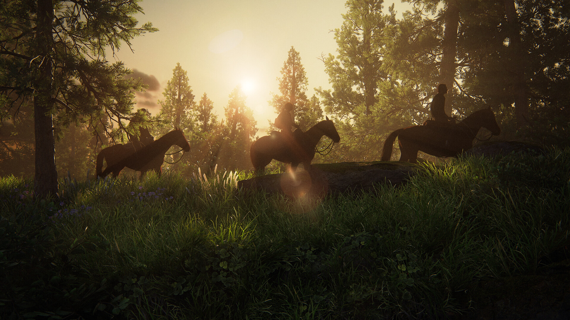 Riders pass through a sunlit forest on horseback.