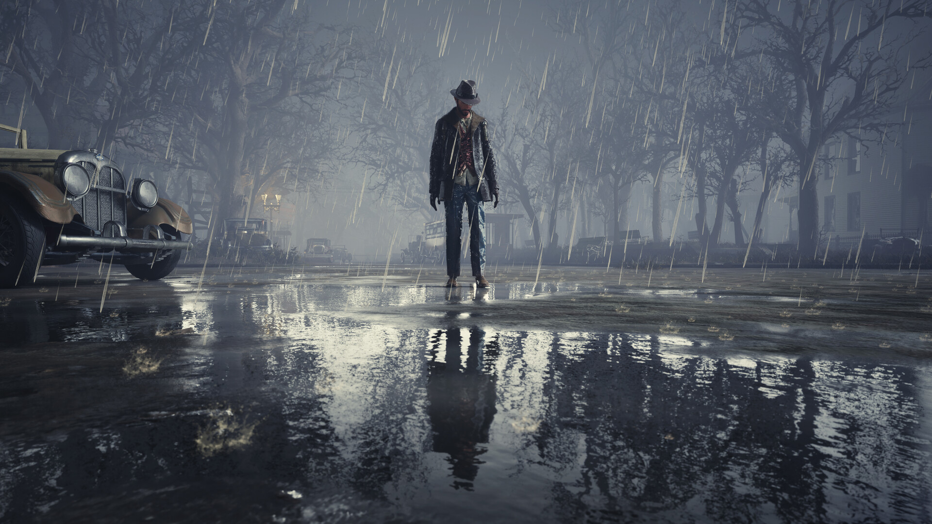 A lone figure stands in a rain-soaked Oakmont street.
