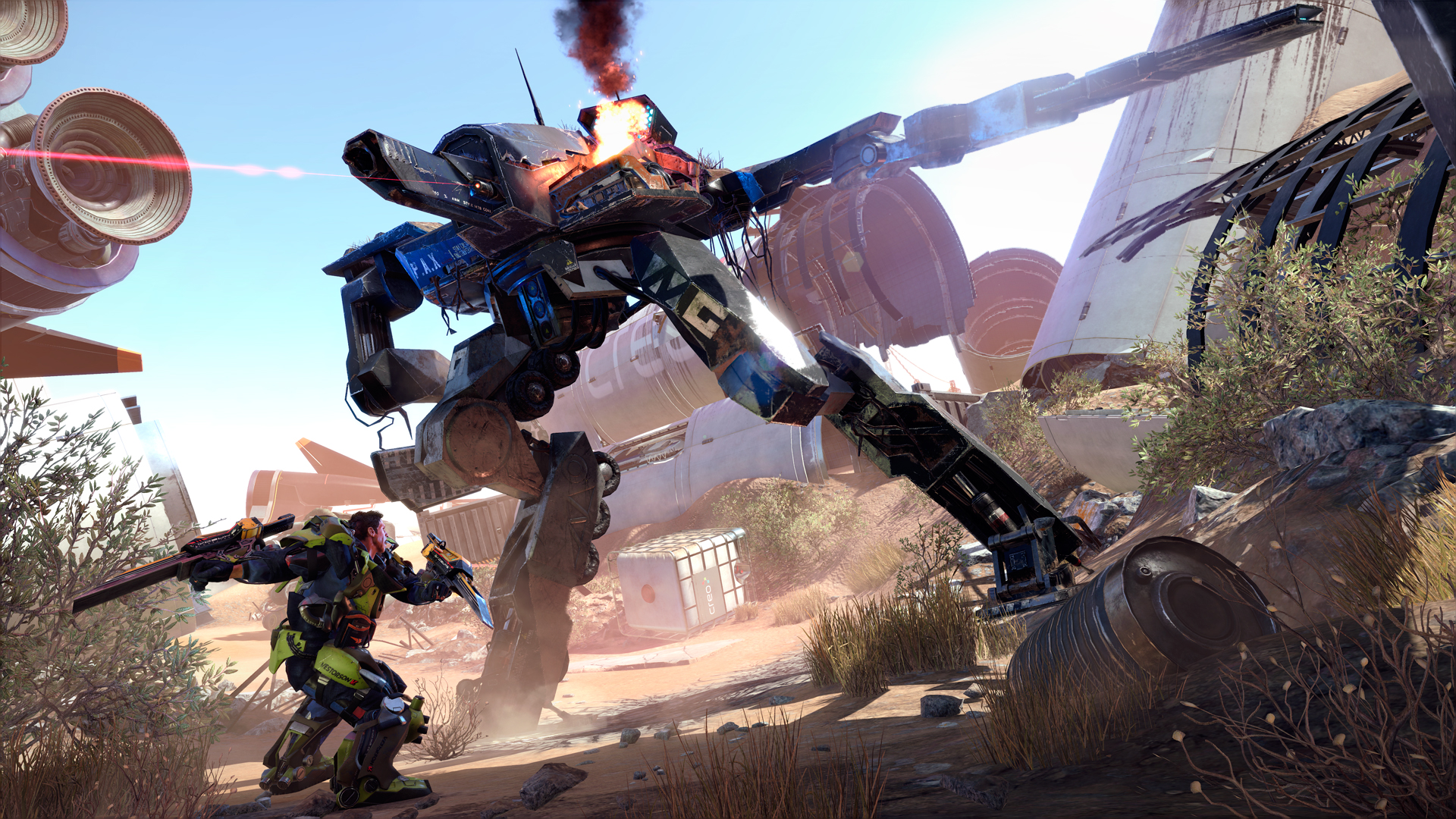 An exosuit fighter battles a large industrial robot outdoors.