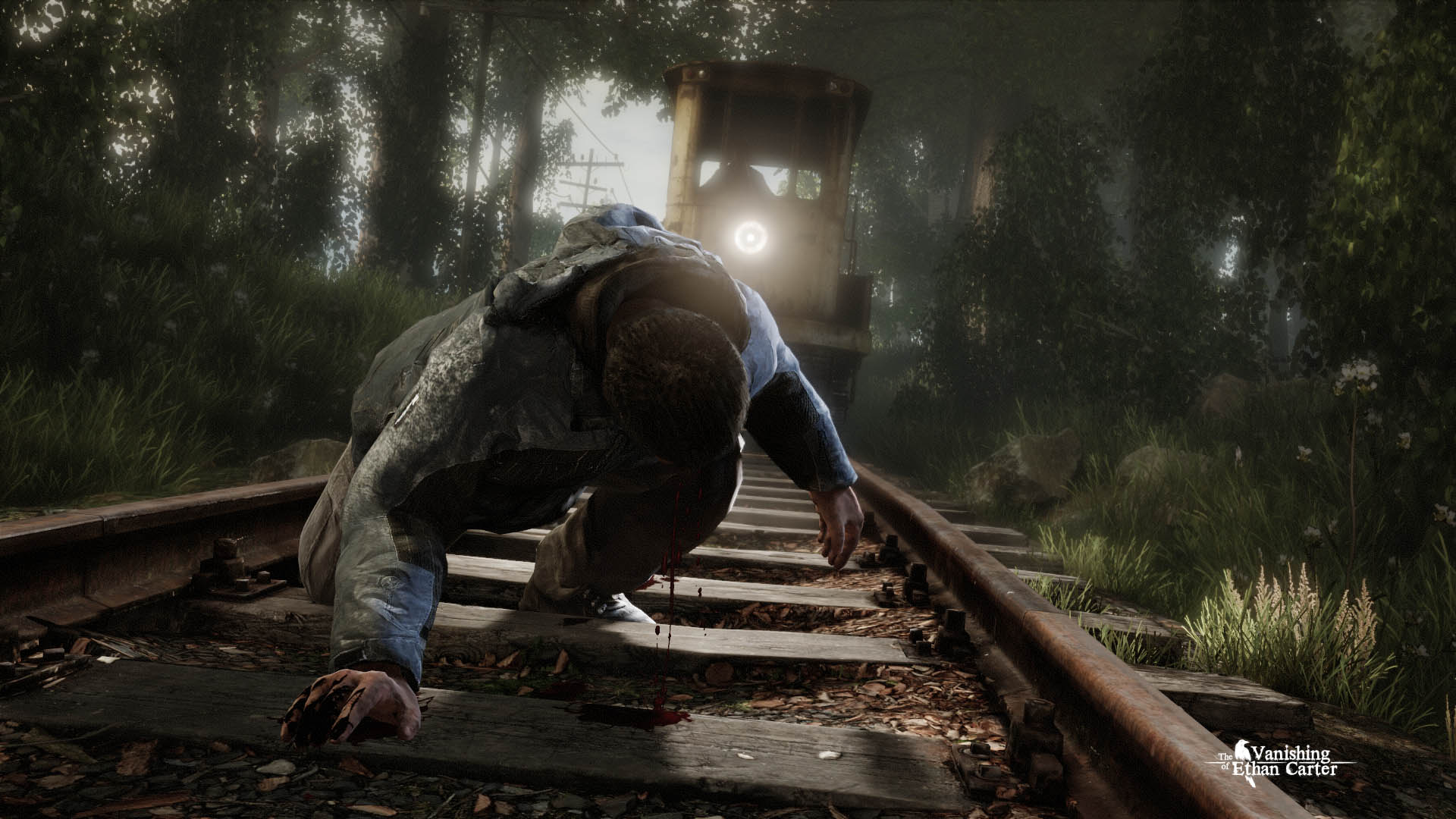 A man struggles beside railway tracks in a forest.