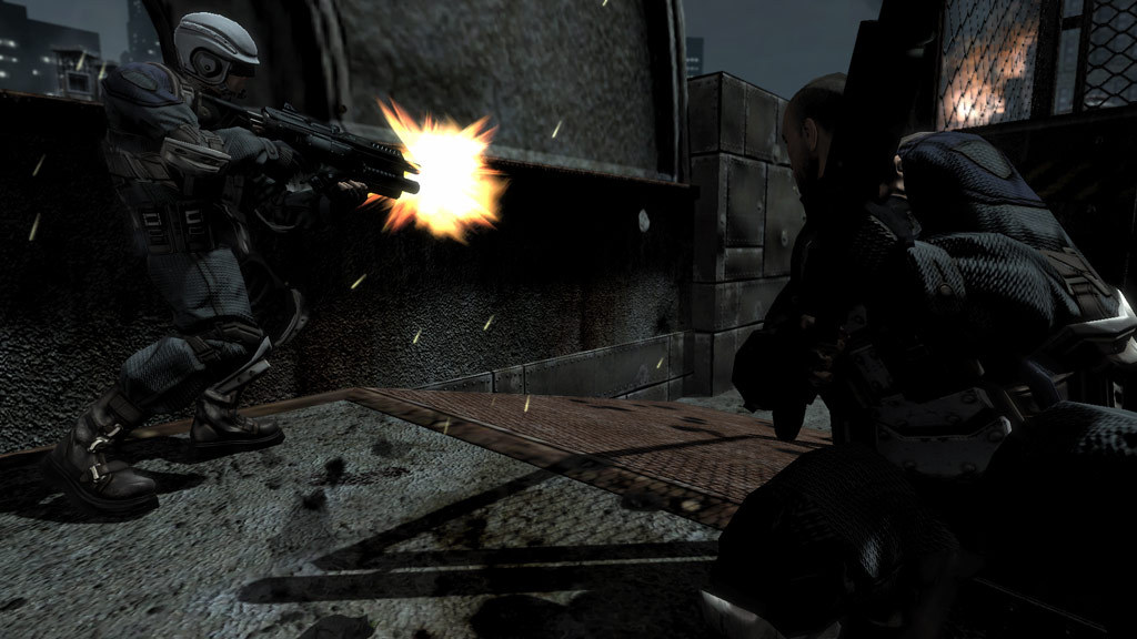 Soldiers fire through a concrete passage.