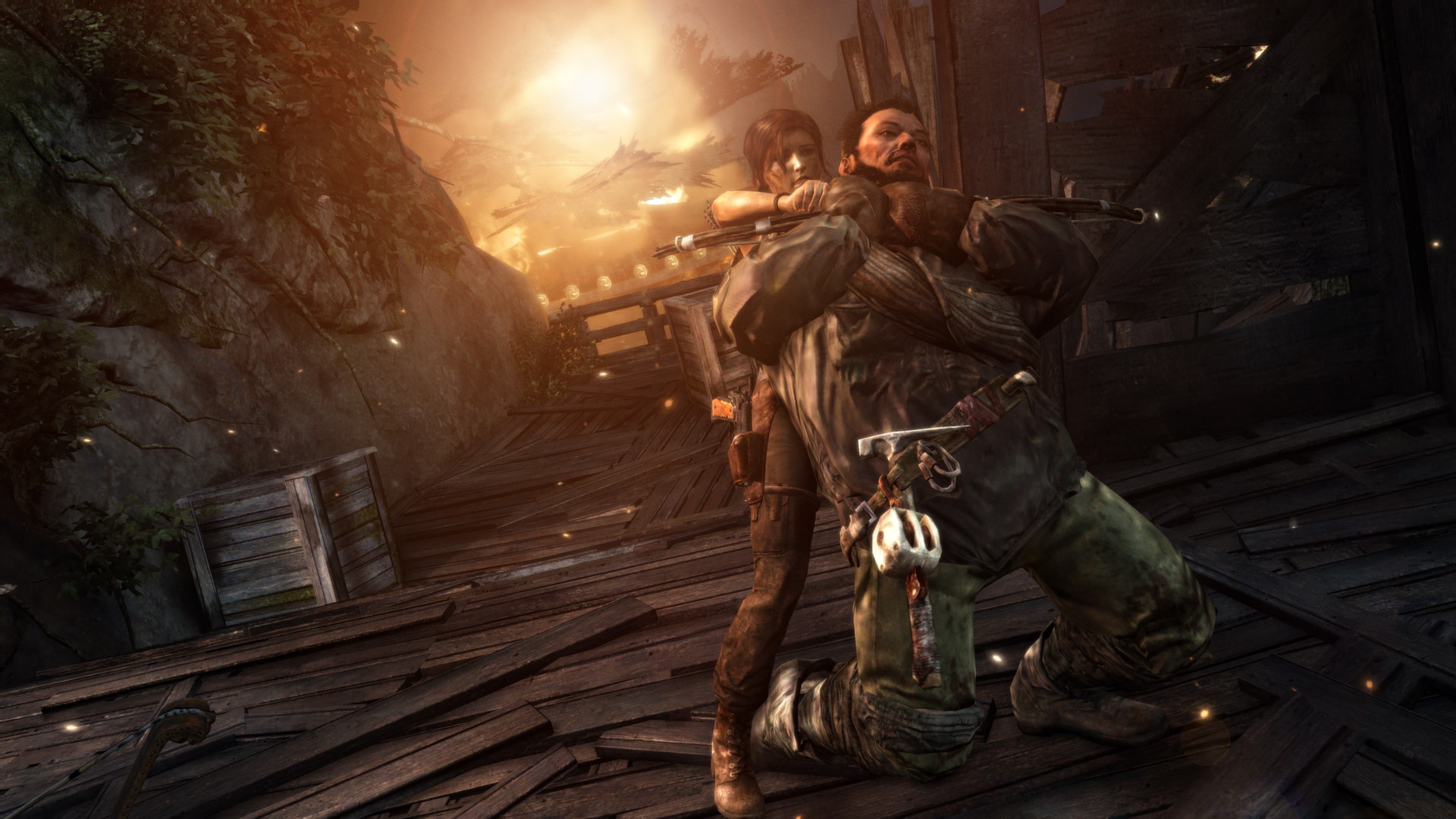 Lara struggles with an armed opponent near a fire.