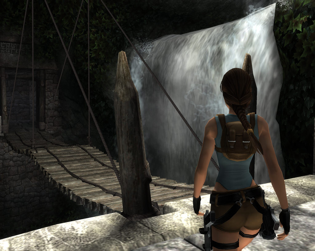 Lara surveys a route through stone ruins.