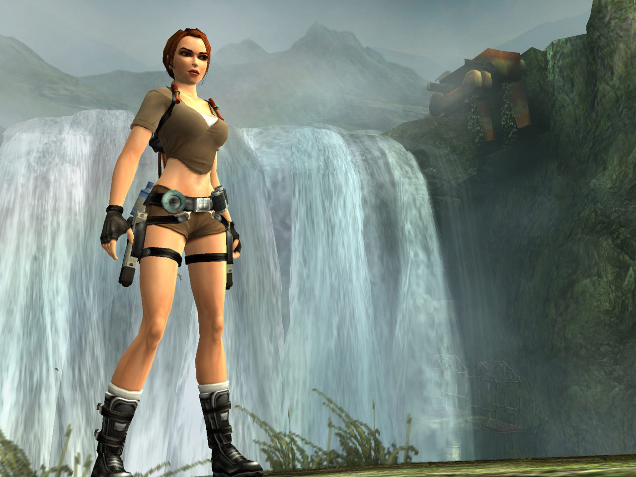 Lara stands near a waterfall during her expedition.