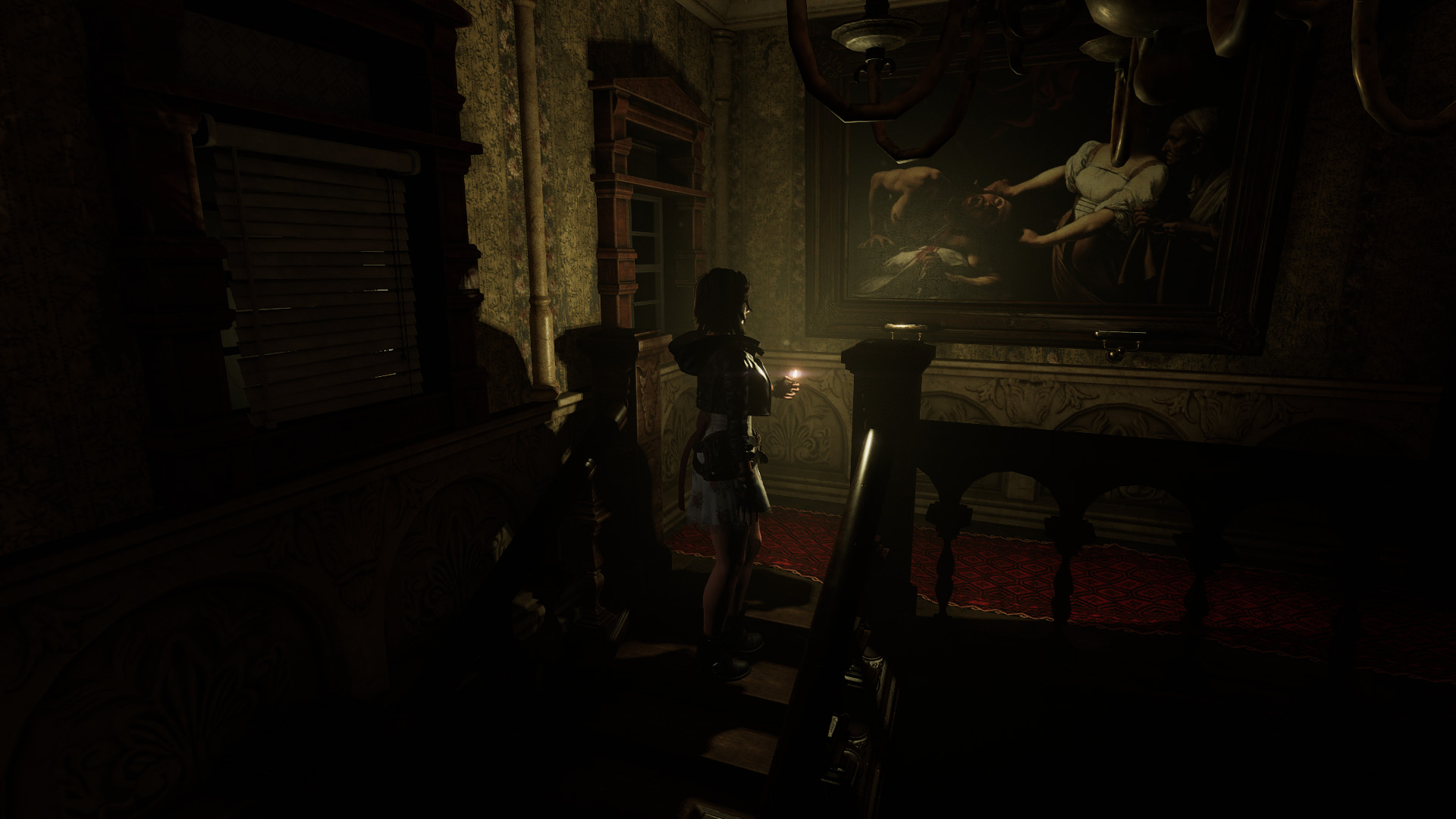 A dark corridor leads toward a statue inside the hospital.