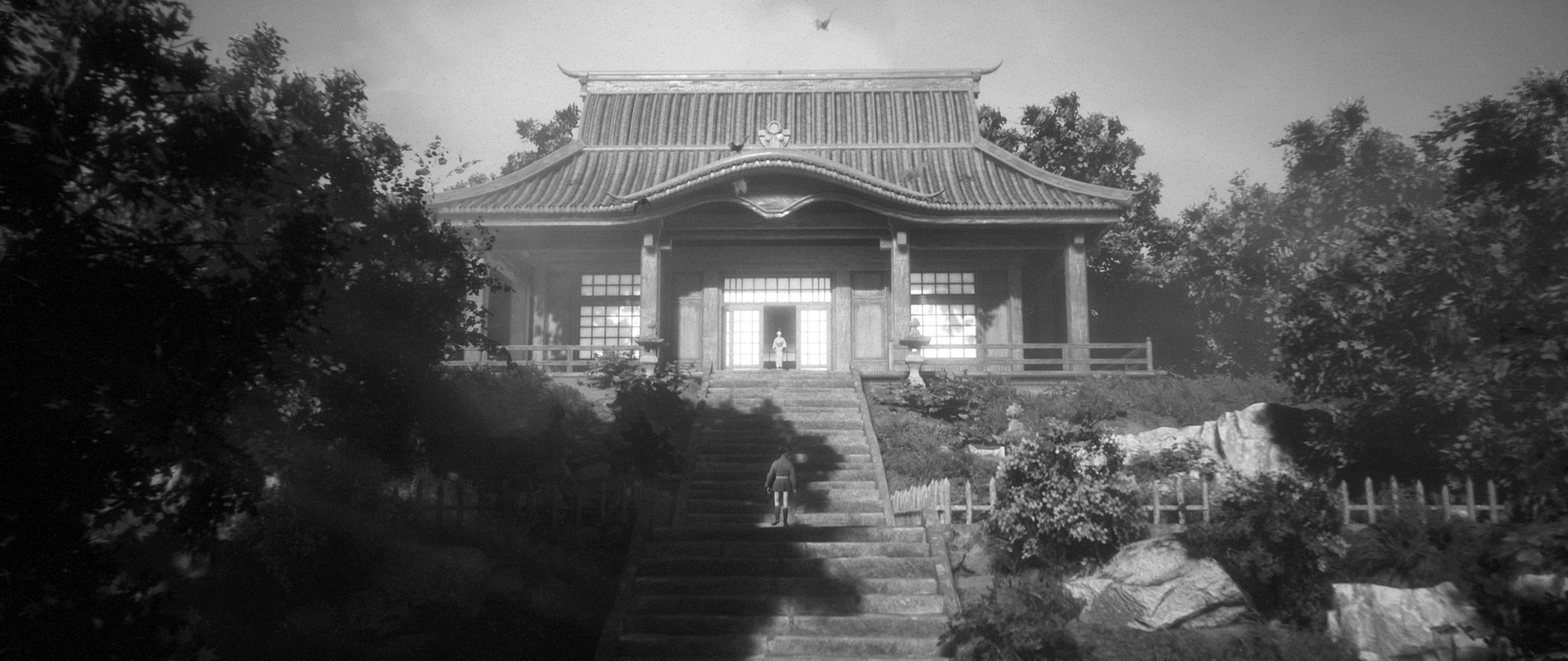 A traveler climbs the steps toward a Japanese building.