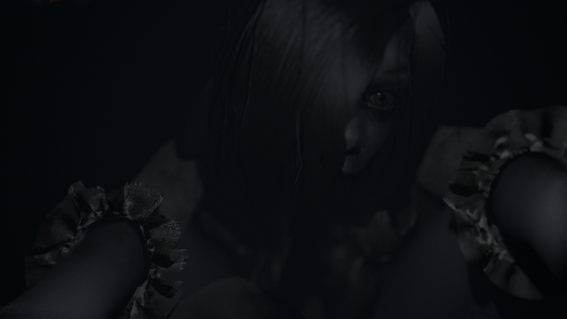 A pale face appears close to the player in darkness.