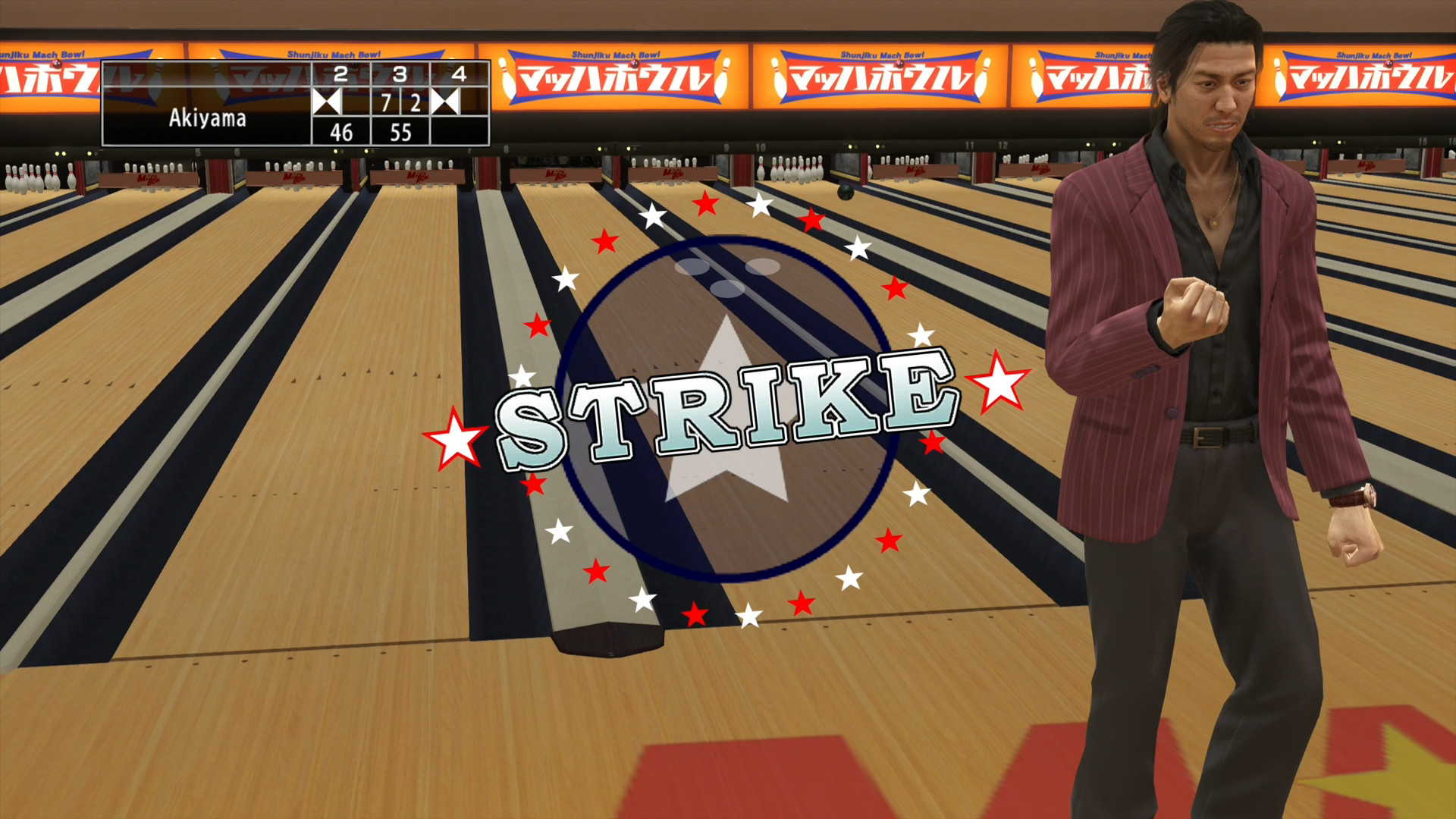 Akiyama celebrates a strike at the bowling alley.