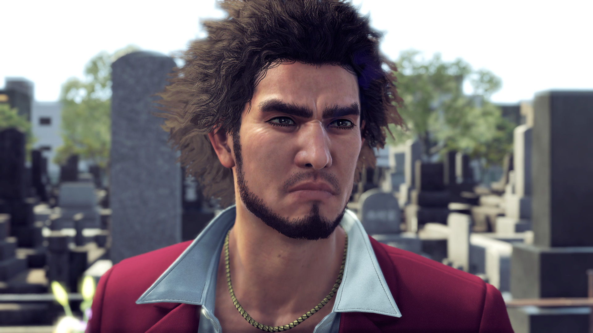 Ichiban Kasuga stands outdoors in a red suit.